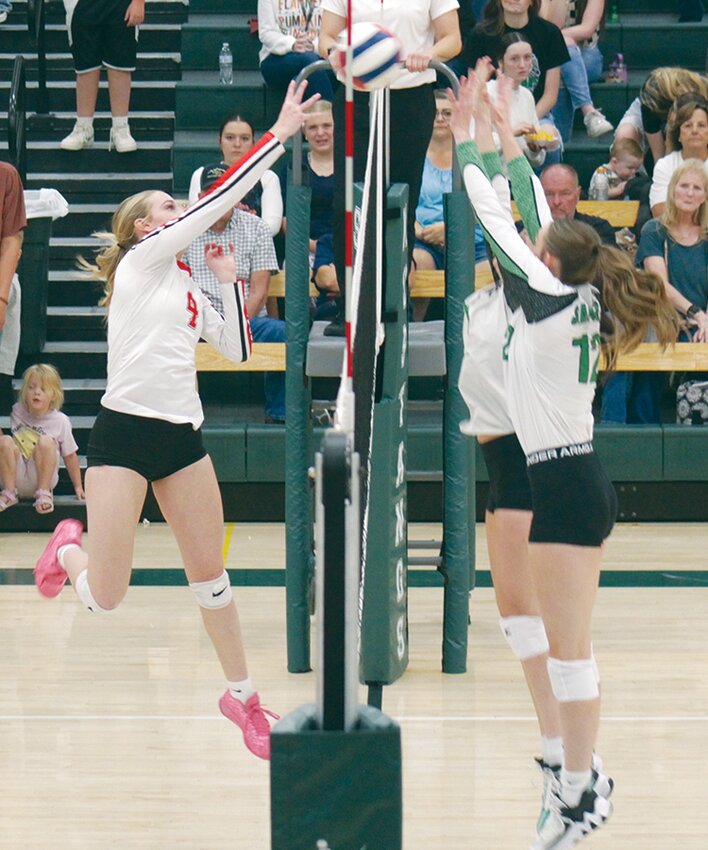 Centauri High School’s Mikasa Giileland (4) hits the ball while Sanford’s Riley Willett (12) goes up for the block in Thursday’s match. The Lady Falcons defeated the Lady Mustangs in three sets.