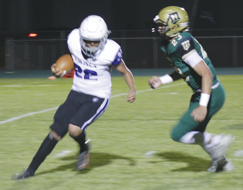 Monte Vista High School’s Manny Jiron (23) pursues Center’s Osmany Roman (22) in Friday’s game at Harvey Sullivan Field. The Pirates defeated the Vikings 79-0.