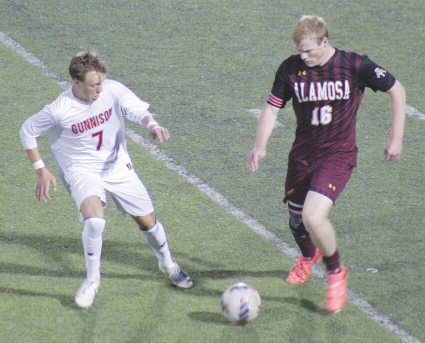 Alamosa High School’s Ben Tibbitts (16) battles Gunnison’s Eli Coop (7) for control of the ball in Thursday’s game at the AHS stadium. Coop scored the game’s only goal in the Cowboys’ 1-0 win.