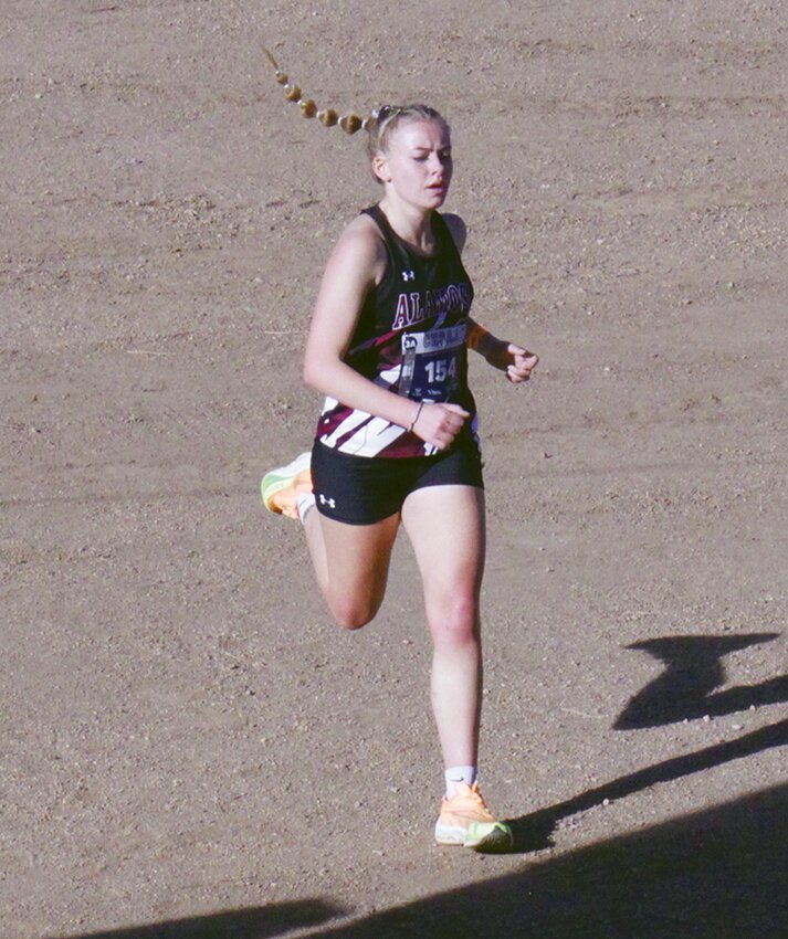 Alamosa High School’s Elizabeth McQuitty crosses the finish line at the state cross country meet in November. McQuitty is currently ranked second in the 3,200-meter run and fourth in the 1,600 in the latest MaxPrep track and field rankings.