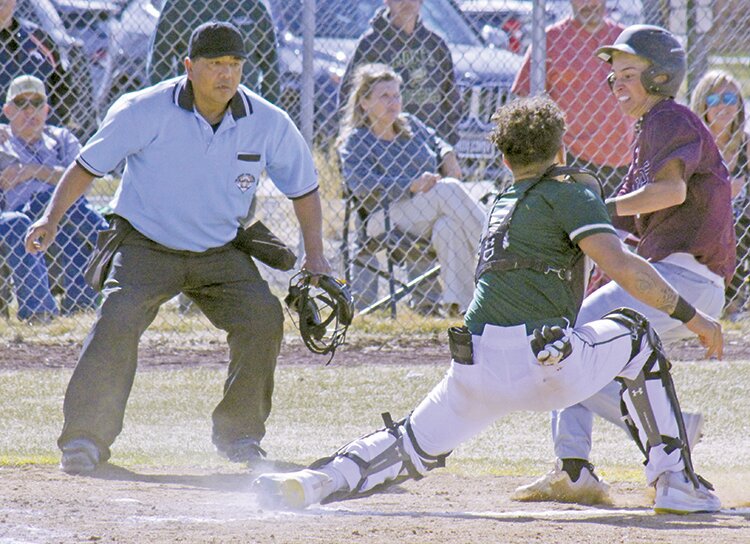 Monte Vista High School catcher Kaden Madrid tags out Alamosa’s Camden Montoya in Tuesday’s game at Adrian M. Gutierrez Field. The Mean Moose defeated the Pirates, 7-1.