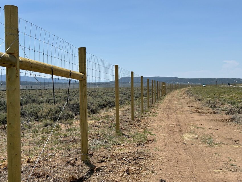 This fence along US 160 near Fort Garland is part of the construction of a wildlife corridor by the Colorado Department of Transportation intended to reduce vehicle-wildlife collisions. 