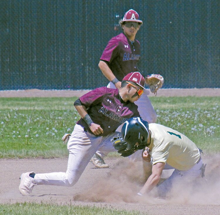 Monte Vista’s Kelby Mondragon (1) slides into second base before Alamosa’s Jaidyn Burciaga can apply the tag in Saturday’s game at Ortega Middle School. The Mean Moose defeated the Pirates 12-8 to win the championship.