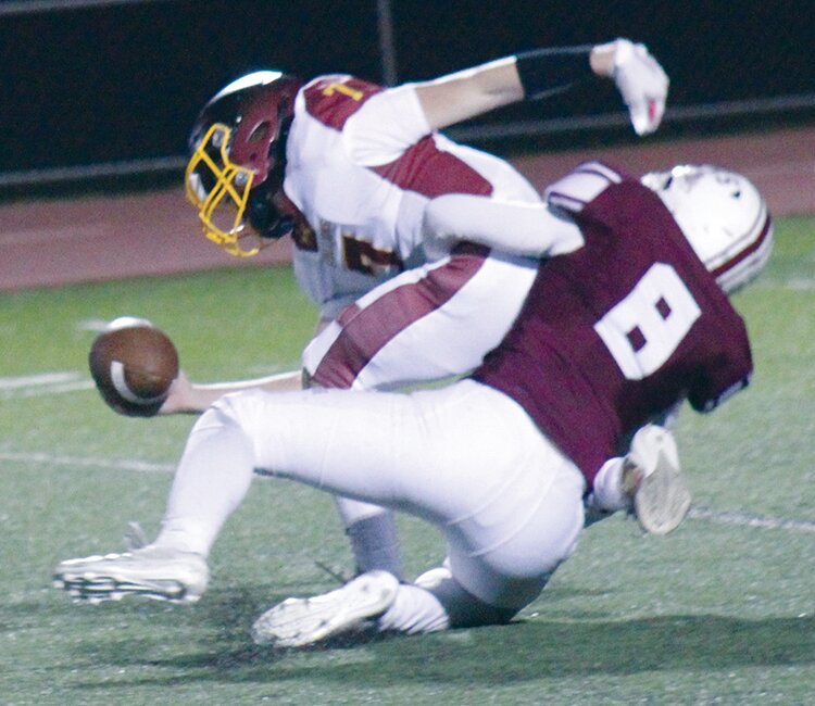 Alamosa High School’s A.J. Baker sacks Banning Lewis’ Sam Early in Friday’s game at the AHS stadium. The Mean Moose won 51-0.