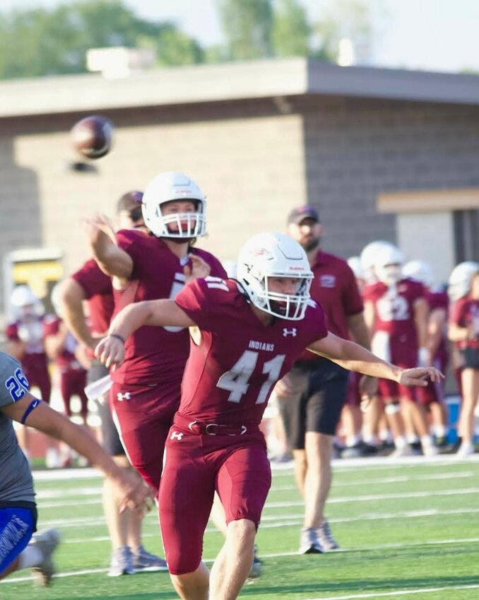 Indians running back/linebacker Jason Colonius (No. 41) looks to lay a block down to protect junior quarterback Maverick Trusty against Harrisonville during the Jamboree on Aug. 23, held at Smith-Cotton High School.