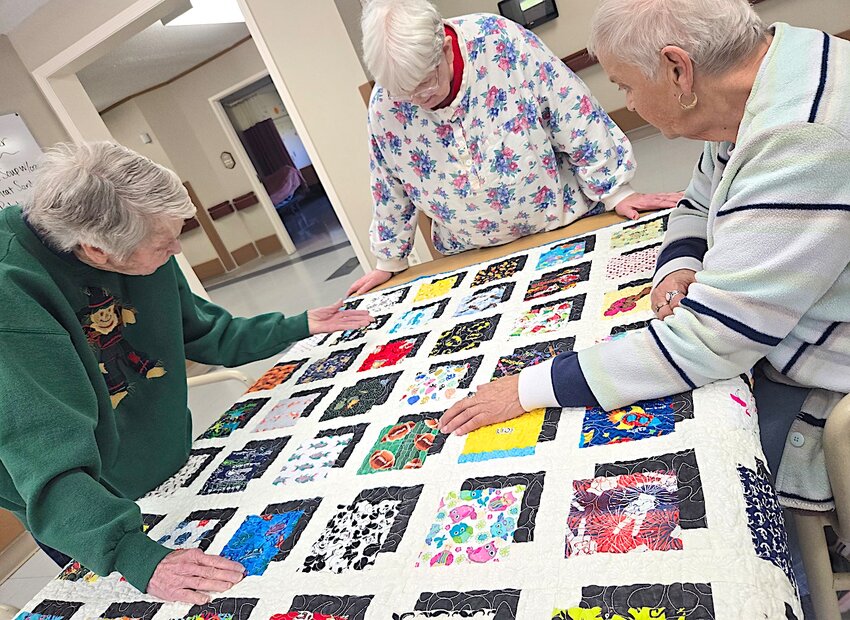 Being a spy
Tipton Oak Manor residents in the memory care unit playing “I Spy” using a quilt to find the items named.