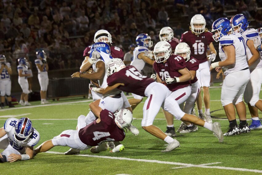 Osage seniors Jason Colonius (No. 41), Issac Williams (No. 15) and Landon Hall (No. 82) force a tackle for a loss on Boonville during the 33-7 homecoming win on Friday, Oct. 11, at the SOTO Athletic Complex.