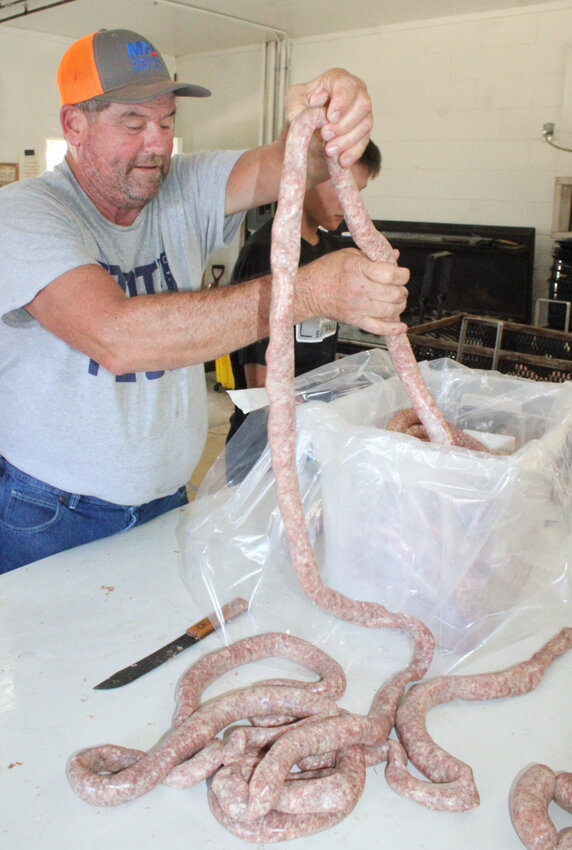 Lots of links – Jerry Rustemeyer works to make links out of a roll of sausage during the St. Anthony Fall Festival Sunday, Oct. 20.