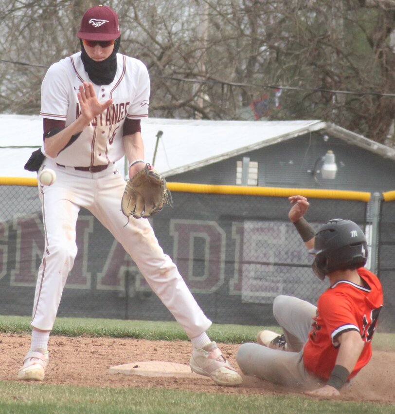 Eldon's Kyle Hinds waits for the throw to come in while Richland's Mason Alexander successfully steals second base during the Mustangs' 13-1 win over the Bears Saturday, march 22, at McMIllen Field.