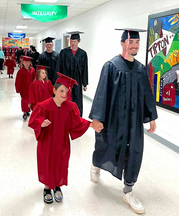 Sharing a name and a walk
Two Peytons, kindergartner Peyton Burch on the left and Peyton Marcum share one of their last walks through the halls of Tipton R-VI Schools Tuesday, May 13. Kindergartners graduated Tuesday night, while seniors will be honored at a commencement ceremony on Sunday, May 18.                   (Photo submitted)