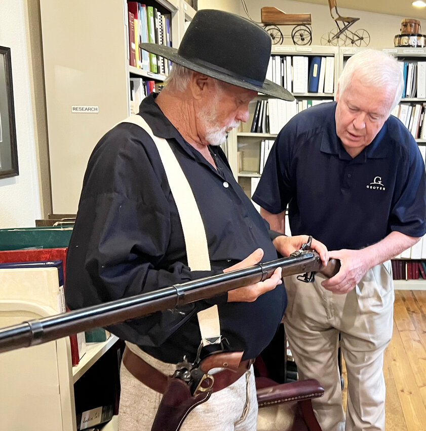 Top caliber inspection – Don Wilson, great-grandson of Bill Wilson (AKA Josie Wales) shows his authentic 1863 muzzleloader to Glen Fraser of Lake Ozark.