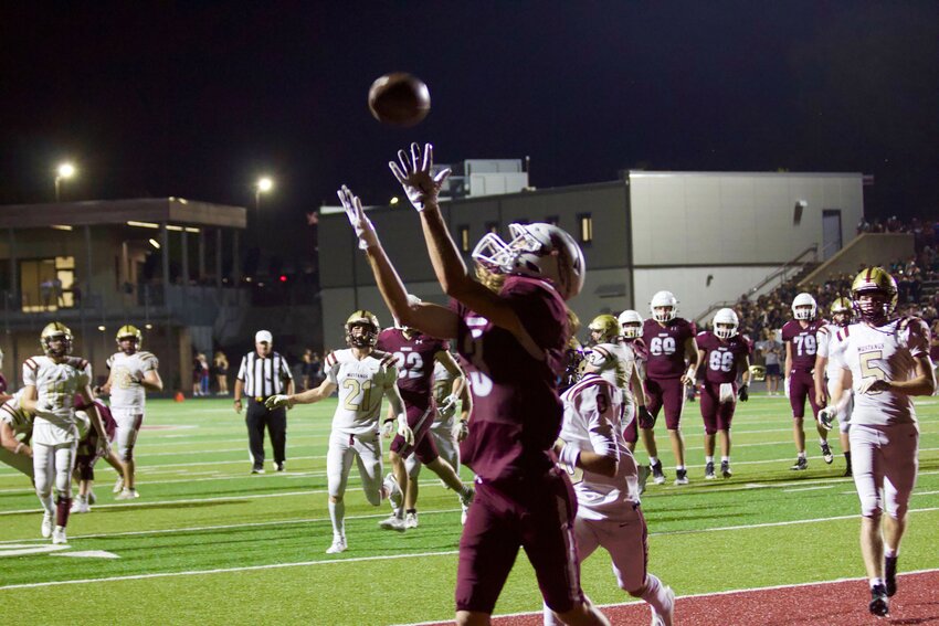 Senior wide receiver Landon Childs (No. 3) reels in a 11-yard touchdown in the third quarter during the 41-22 win over Eldon on Friday, Sept. 20, at the SOTO Athletic Complex.