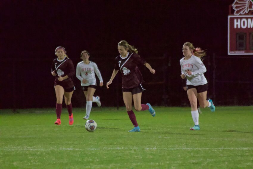 Junior midfielder Ella Glover (No. 7) dribbles up the field against Jefferson City in a 2-1 loss in OT on Monday, March 31 at the SOTO Soccer Field.