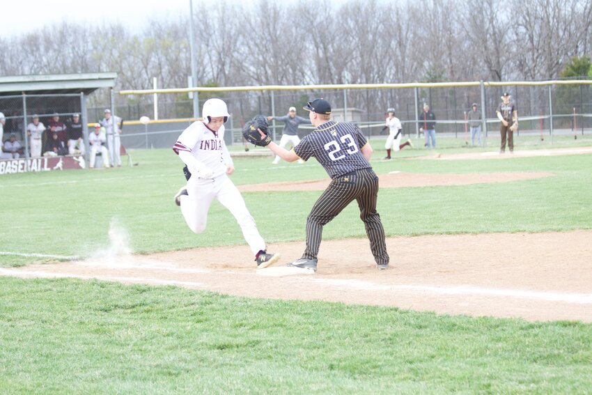 Indians junior centerfielder Tyler Marshall (No. 5) beats the tag to reach first base on a base knock as Osage shutout Versailles 9-0 on April 1.