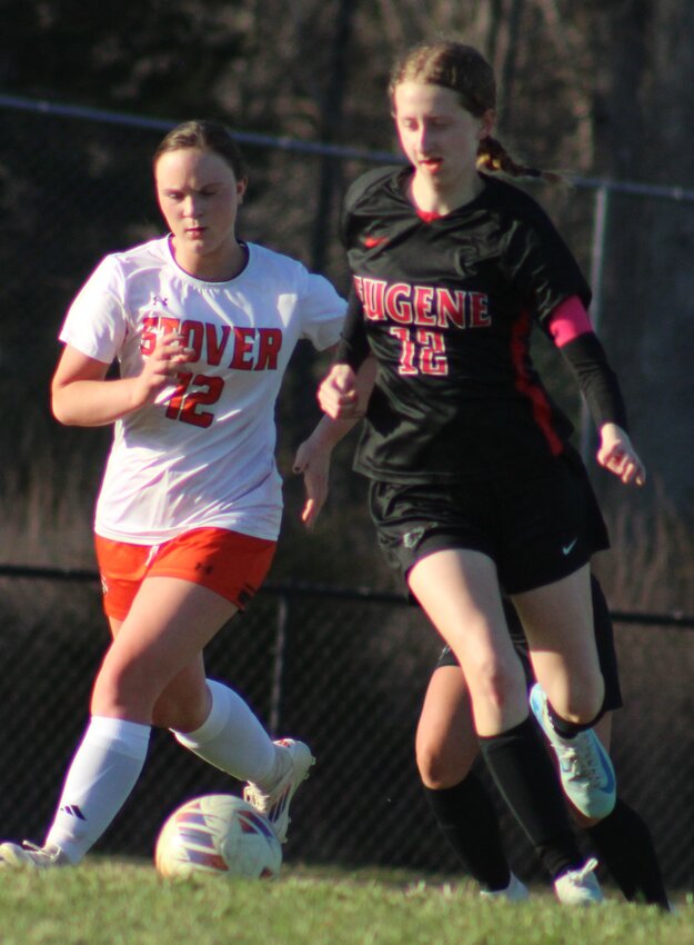 Eugene's Alexei Burkett tries to work the ball around Stover defender Olivia Pilant during the Lady Eagles' 2-1 win over the Lady Bulldogs in varsity soccer action Tuesday, April 7, at Eugene.