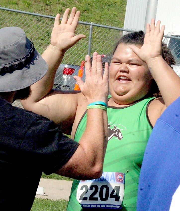 Iberia’s Adara Langatua shares a high 10 with her coach Matt Trusty after Langatau’s throw of 40.26 meters in the discus during the MSHSAA Class 2 Girls Track and Field Championships Friday, May 23 in Jefferson City. The throw was good enough to clinch the state championship.