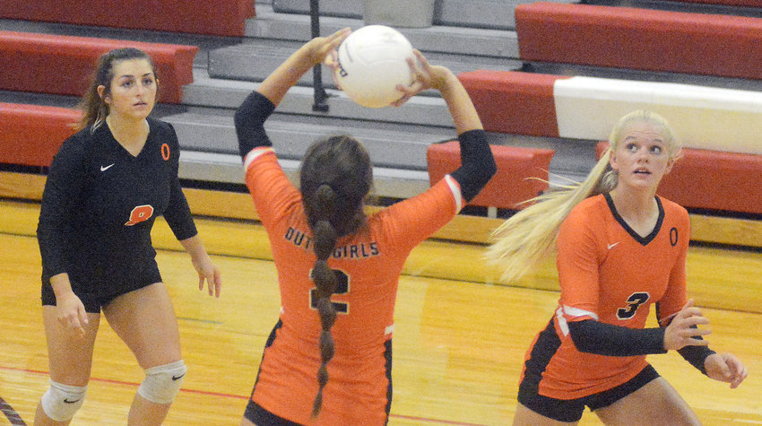 Kylie Kitchen (above, center) sets the ball while Olivia Vandegriffe (above, far left) and Josie Gerlemann (above, far right) watch the ball to see where it is set during Owensville&rsquo;s three-set victory last Tuesday night in Belle.