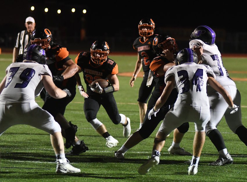 Austin Lowder (above, center) waits for a hole in the Pacific Indian defense before scoring on an 8-yard touchdown run with 1:02 remaining in Owensville&rsquo;s 57-42 homecoming victory.