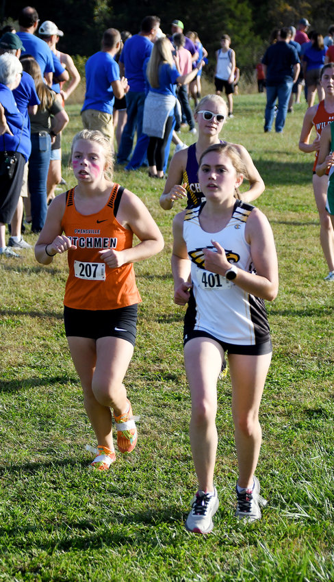Abbie Gibson (above, left) shows off pink face paint during the varsity girls race during last Tuesday&rsquo;s Owensville Invitational Cross Country meet on the Gasconade County R-2 Campus.