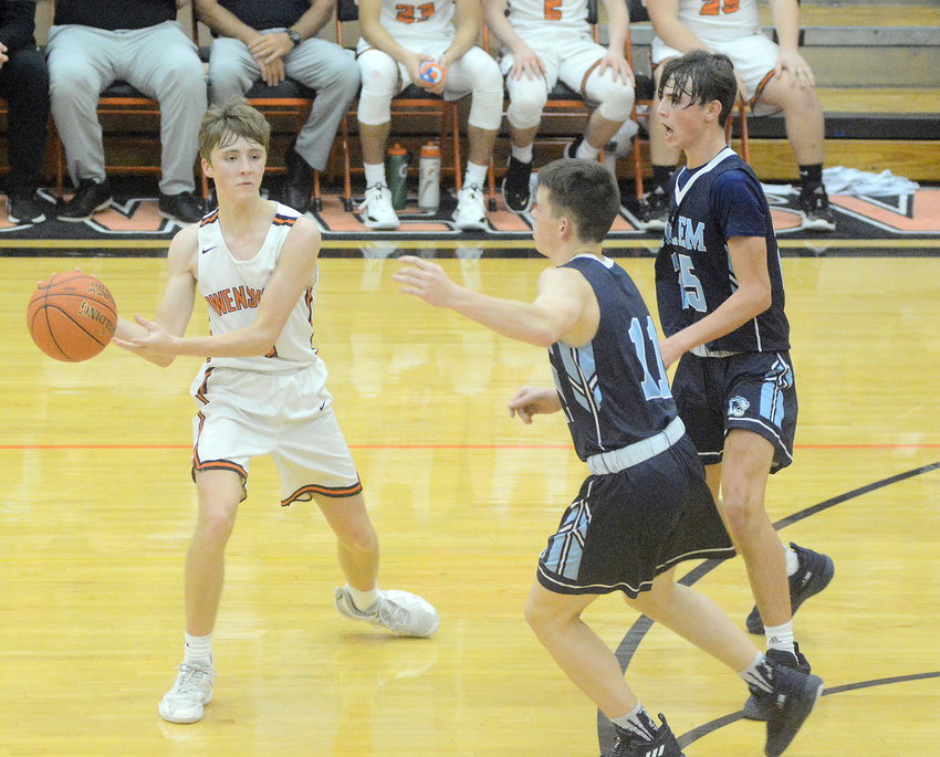 Will Lauth (left) looks to pass the ball with a pair of Salem Tiger defenders closing in on him Friday night at Owensville High School.