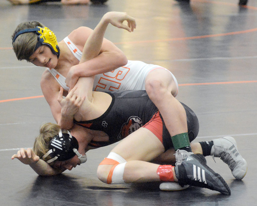 Michael Martin (white singlet) looks to turn St. James&rsquo; Blake Marlatt over on his back during the second annual Four Rivers Conference (FRC) Wrestling Tournament held earlier this month at Owensville High School.