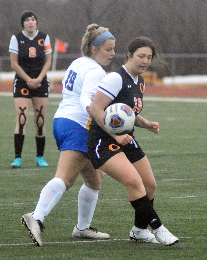 Avery Bastunas (right) stays in front of Fatima&rsquo;s Avery Brandt while in pursuit of the soccer ball for Owensville&rsquo;s Dutchgirls during their season-opening match Friday night at Dutchmen Field.