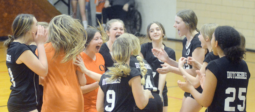 Seventh Grade Owensville Dutchgirl volleyball team members celebrate completing their perfect 16-0 season following a two-set victory over Bland&rsquo;s Lady Bears Friday night at Bland Middle School by scores of 25-10 and 25-7.