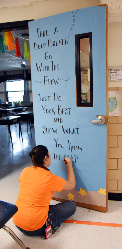 Gerald Elementary School fifth-grade teacher Olivia Reiker finishes a door covering Monday ahead of upcoming MAP testing which encourages her students to &ldquo;go with the flow&rdquo; and not worry about the process.