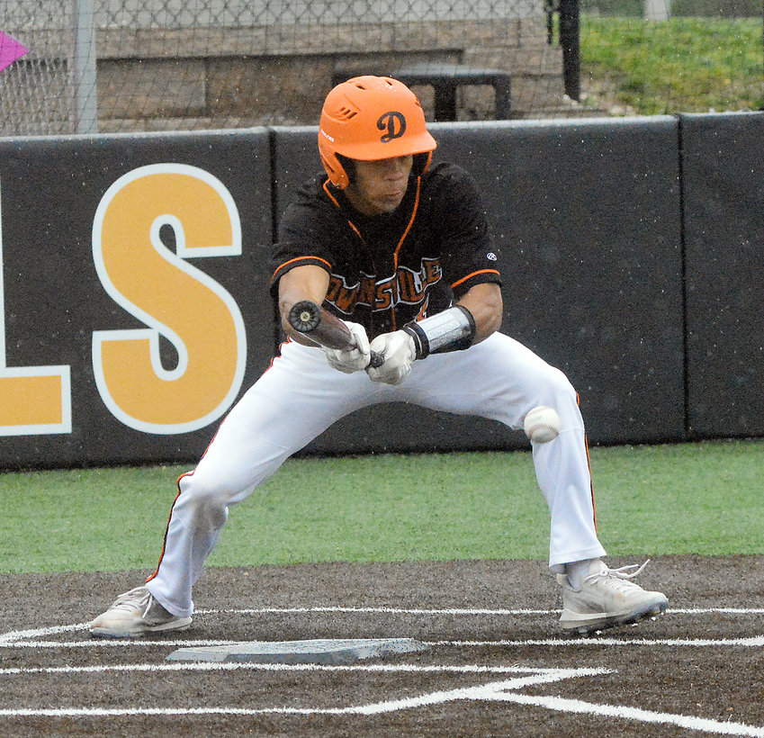 Dezmyn Moore squares to bunt during Owensville&rsquo;s 7-6 loss to Hermann in game one of a Four Rivers Conference (FRC) varsity baseball twin bill at OHS Field last Wednesday in rainy conditions.