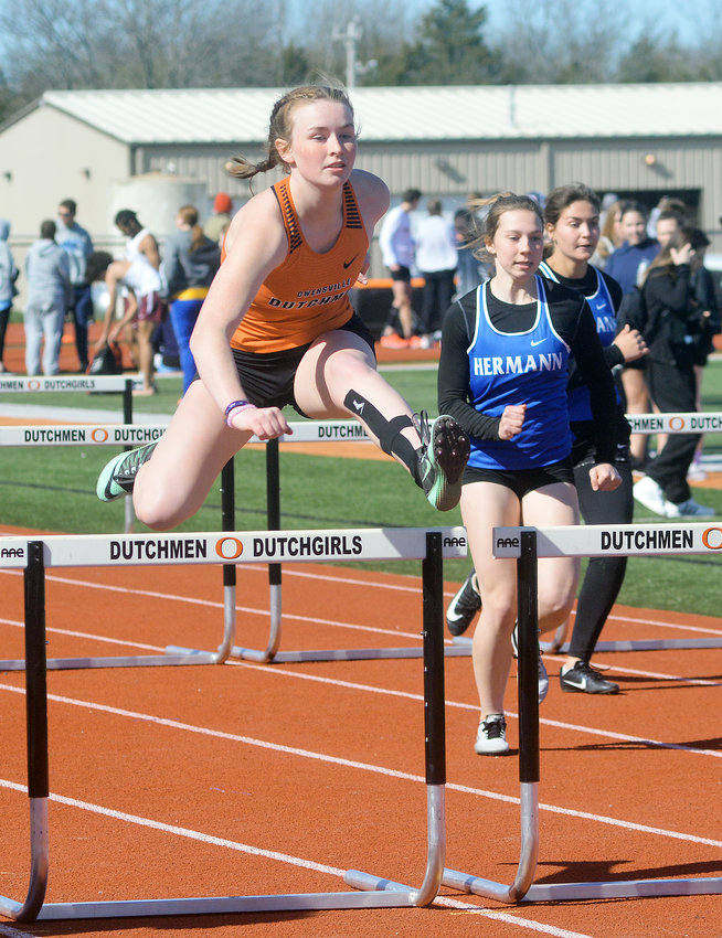 Kiera Finn (left) clears one row of hurdles while competing in the girls 100-meter hurdles during the annual Owensville High School (OHS) Relays track meet held back in April at OHS&rsquo; Dutchmen Field. Finn will continue her academic and athletic pursuits for the Lady Cardinals at Mineral Area College in Park Hills, Mo.