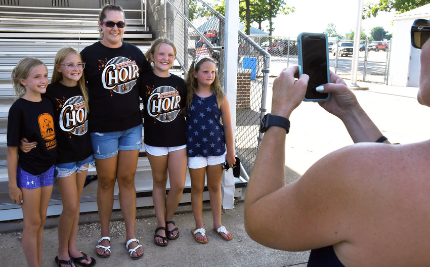 Erin Sassmann gathers for a group photo with (from left) Emilee Huebler, Kensley Harness, Brooke Tainter and Raegan Tainter after the annual Fireman&rsquo;s Picnic on what was her last official event as Owensville Elementary&rsquo;s choir director.