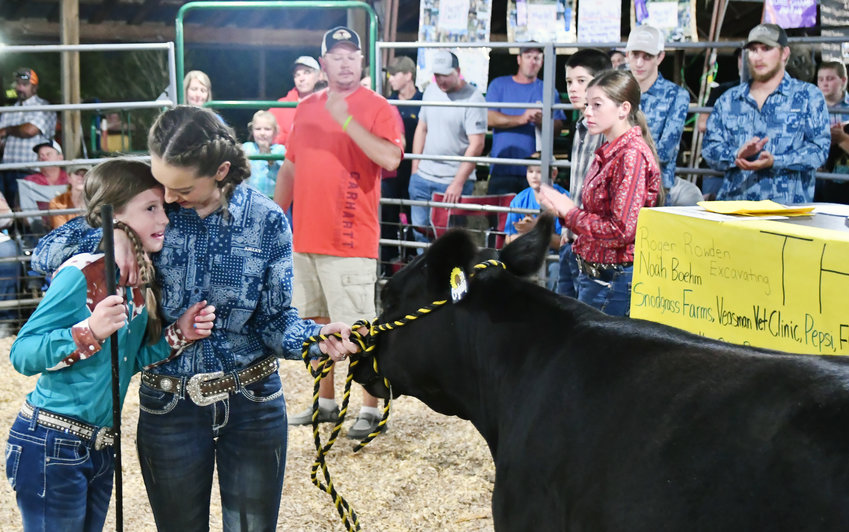An emotional moment was when a heifer donated by the Jeff and Jessica Stricklan family in honor of Cody Stricklan, was auctioned with big community support. The heifer brought in over $40,000 toward the new addition planned for the hog barn.