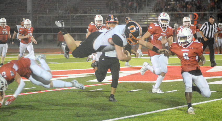 Garrett Crosby (center) turns into a flying Dutchman during Owensville&rsquo;s 12-6 overtime victory on the road Friday night in Warren County over Warrenton&rsquo;s Warriors. This marked Owensville&rsquo;s first victory against Warrenton since a 45-14 win over the Warriors back in 1997.