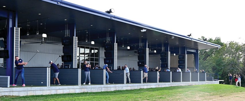 Instead of a traditional ribbon cutting, State Tech went a different direction, with 12 individuals taking a ceremonial first swing in the new bays at the driving range on Thursday.