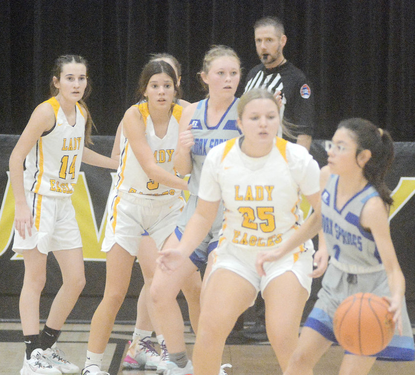 Lady Eagle defenders (from left) Brooke Mercer, Aubrey Reeves and Marissa Hollis keep an eye on the basketball in the hands of Climax Springs&rsquo; Lizette Rivera.
