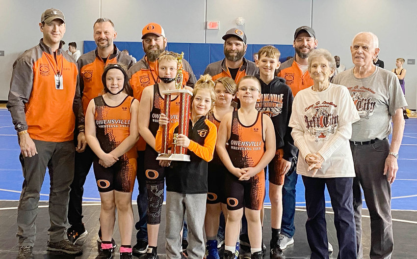 Owensville Wrestling Club coaches and wrestlers proudly gather for a group photo after being presented with the Sportsmanship Award from the Casey J. Luebbert Memorial Youth Wrestling Tournament in Jefferson City held at Capital City High School. This is the second time that the orange and black have been recognized for their sportsmanship over the past few years. In addition to bringing the sportsmanship trophy back to Owensville, six wrestlers left Jefferson City with medals for top-three finishes in their respective weight classes.