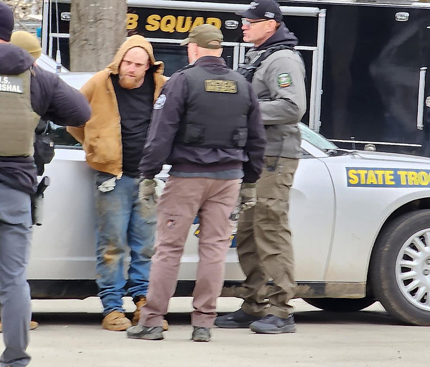 KENNETH LEE SIMPSON is pictured in custody after lawmen fired tear gas into the residence at 102 Market Street in Hermann on Monday afternoon.