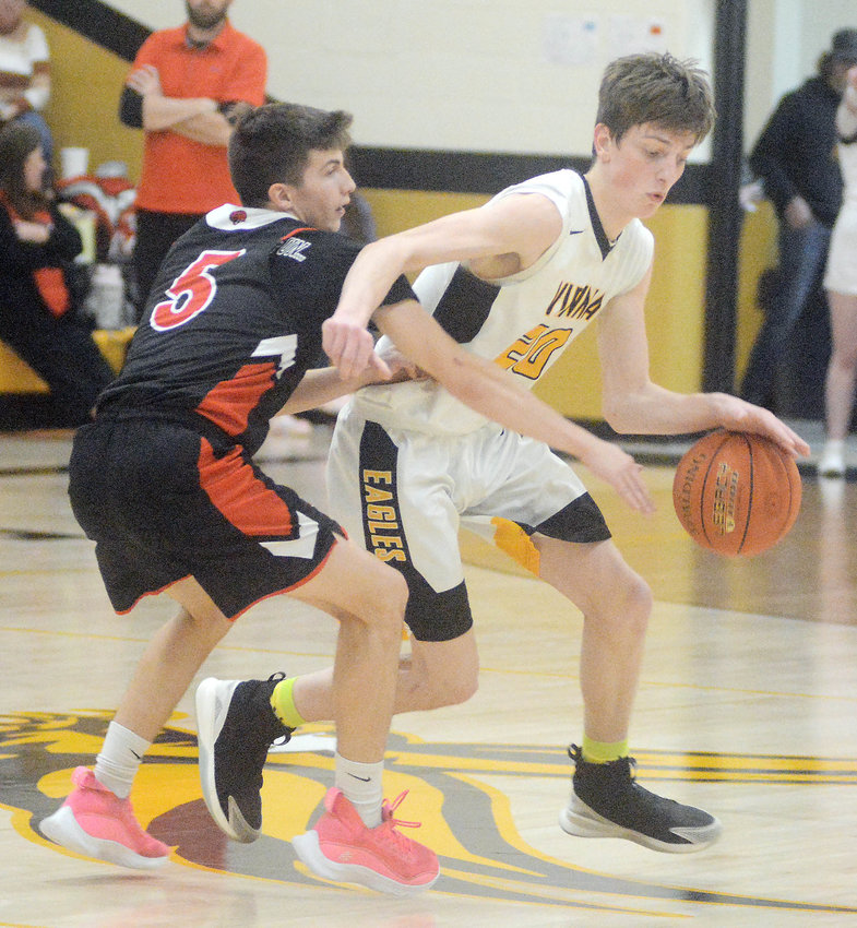 Cash Stricklan (far right) keeps the basketball away from Belle&rsquo;s Brayden Cadwallader during the annual Battle of Maries County hoops showdown at Vienna High School.