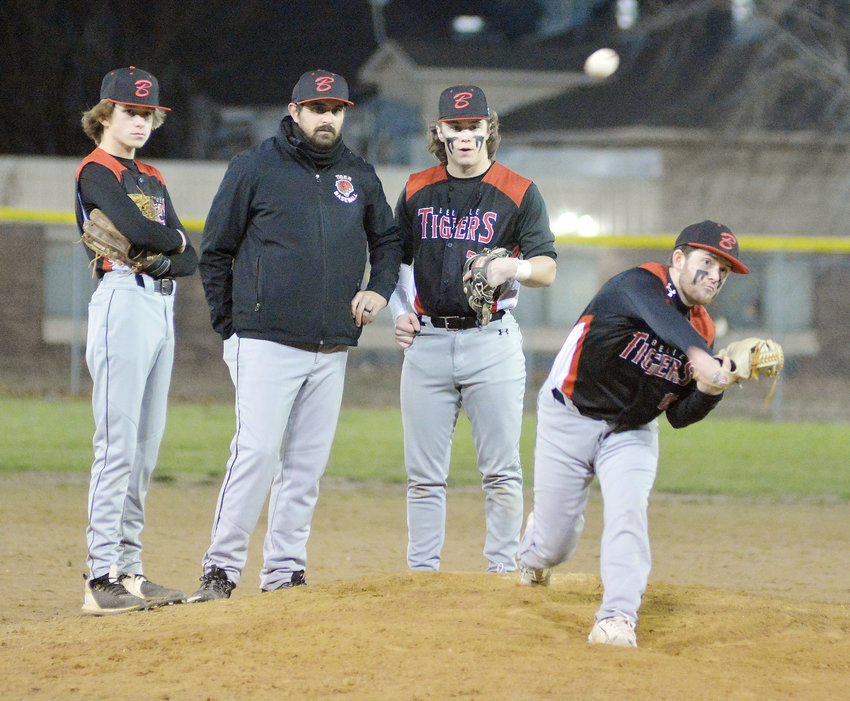 Kameron Newton (far right) warms up before pitching the final six innings of Belle&rsquo;s 8-3 victory over Rolla&rsquo;s JV Bulldogs Monday night during opening-round action of the Stoutland Spring Classic at Vienna City Park. Weather and field conditions permitting, Belle is scheduled to square off against Vienna in tournament semifinal action at 7 p.m., in Vienna.