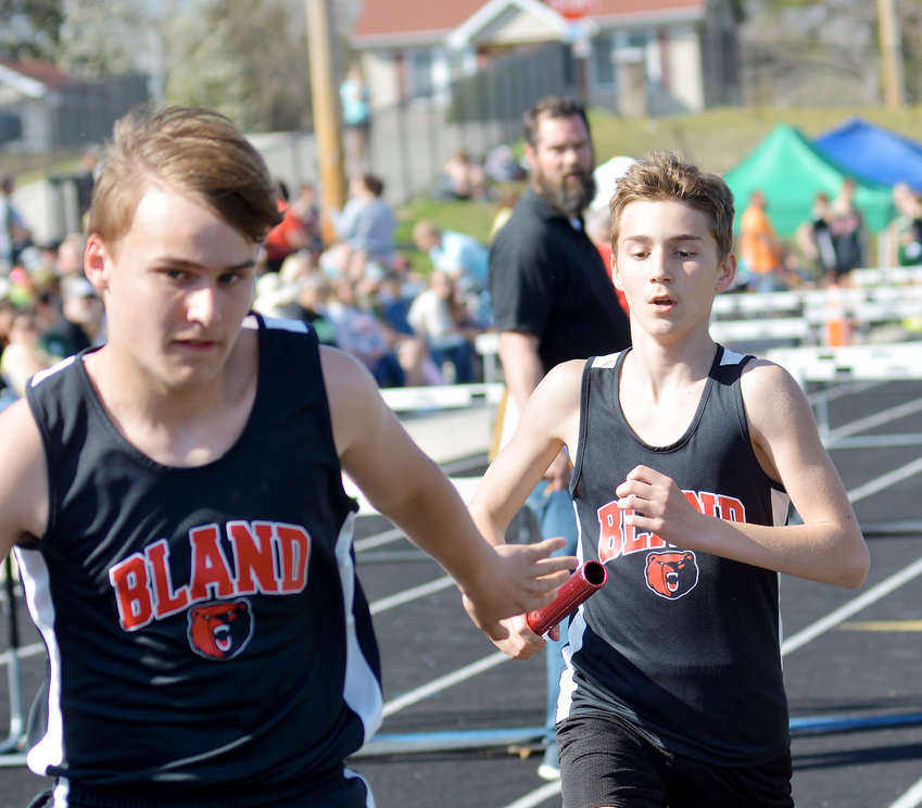 Miles Frey (far left) reaches back for the baton from Malachi Fredendall for Bland&rsquo;s Bears during the boys 4x800-meter relay during the Vienna Middle School (VMS) Eagle Classic held at Vienna High School&rsquo;s track.