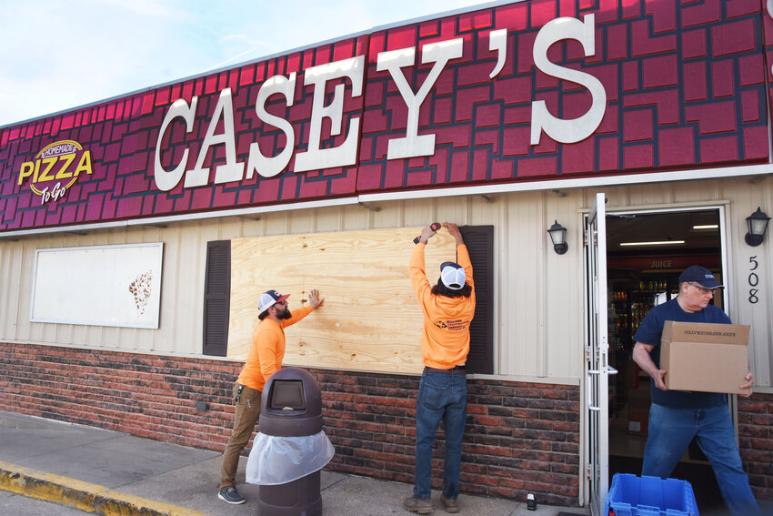 Williams Construction crew members boarded up the store this past Wednesday as Paul Hefley with the Helping Hands Outreach Center of Gasconade County removes snacks, food items, and miscellaneous household products which were being donated to the food pantry.&nbsp;