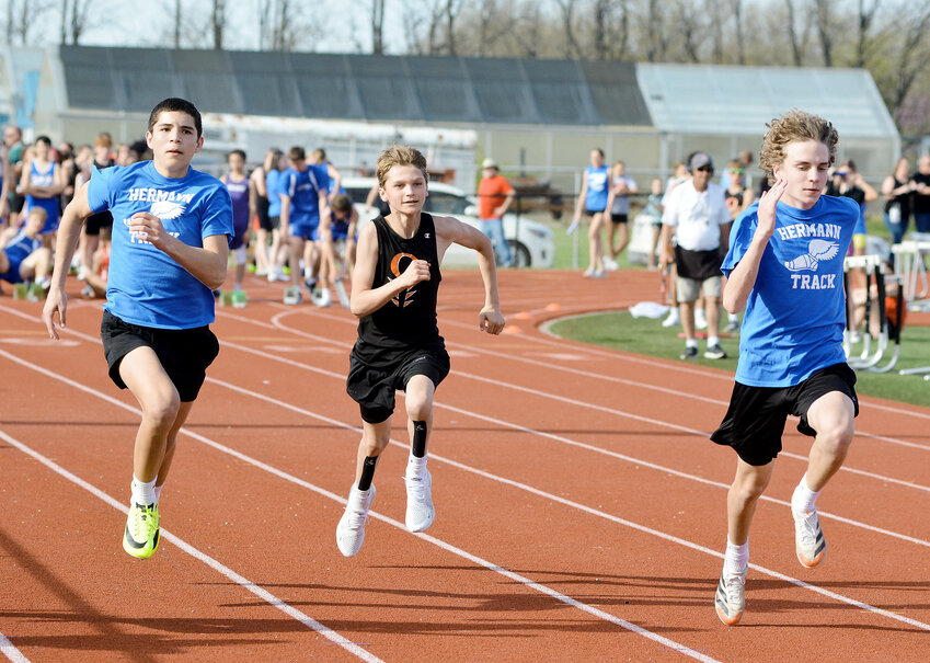 Charlie Katsov (center) finds himself in the middle of a (Hermann) Bearcat sandwich in one of five heats of the boys 100-meter dash during Thursday&rsquo;s Owensville Middle School (OMS) Relays. Hermann runners (from left) racing with Katsov were Kobe Grannemann and Ryker Ash.