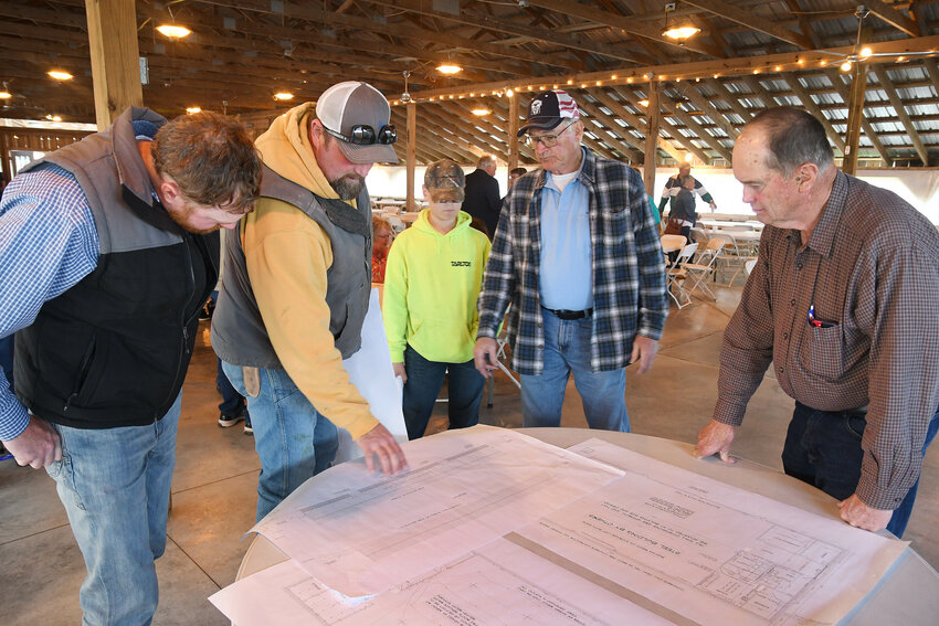 REVIEWING PLANS for the proposed facility are (from left) Chad Raaf, Joe Fredrick and his son, Jordan, Nick Baxter, and Ron Hardecke.