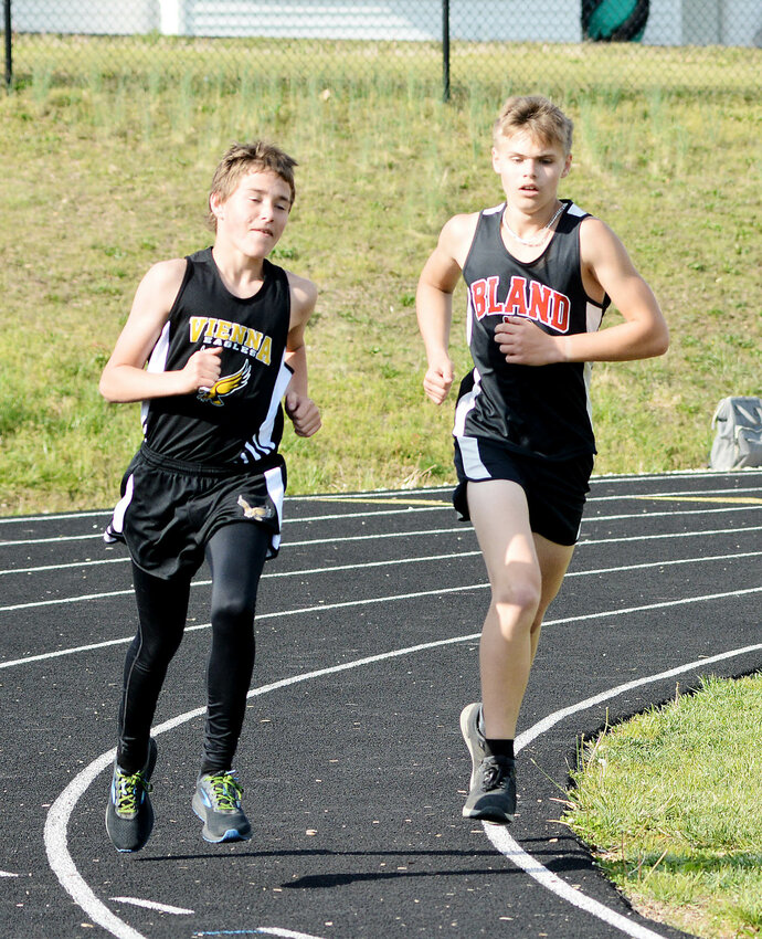 Dalton Timm and Karsin Siefert (from left) represent Maries County in the boys 1600m run during Vienna&rsquo;s Black and Gold Invitational track meet Monday.