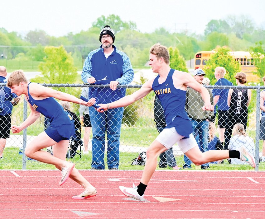 Tyler Koenigsfeld hands the baton to Tyler Kloeppel in Friday&rsquo;s conference 800m relay at New Bloomfield.