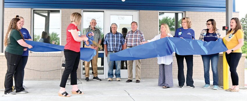 Osage County Health Department Administrator Kim Sallin cuts the ceremonial ribbon at Friday&rsquo;s Grand Opening for the new building. She was joined by OCHD employees and Western District Commissioner Larry Kliethermes, Eastern District Commissioner John Trenshaw, and Presiding Commissioner Darryl Griffin.