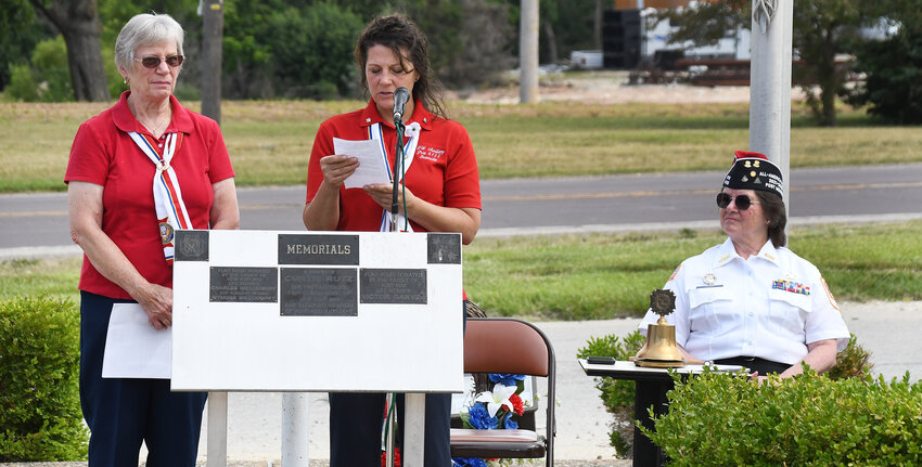 VFW Post No. 6133 Auxiliary members Joyce Baxter (left) and Tina Medlock present the reading for a memorial wreath laying ceremony Monday during the post&rsquo;s Memorial Day  service. Post member Sandy Harris is pictured on the right.