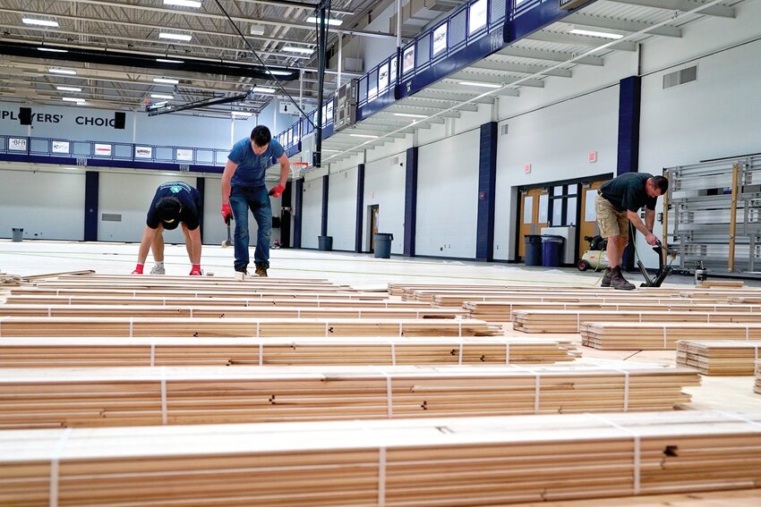 Charles Luebbert Flooring employees work on the floor at the State Tech Activity Center.