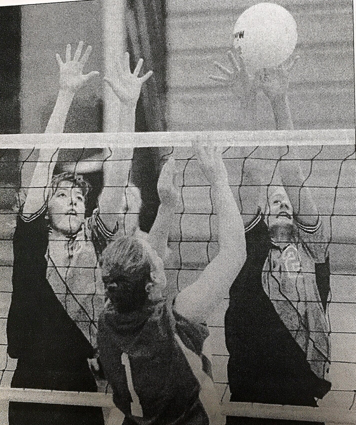Jaime Diestelkamp Nelson (right) blocks a kill attempt during the Owensville Volleyball Tournament back in the fall of 1999. Former teammate Rebecca (Angell) Hasemeier (left) also has her hands up to help block.