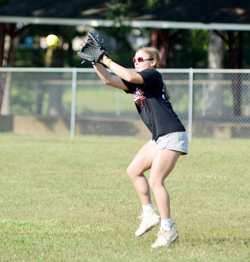 Aubrey Rehmert catches a ball before throwing it on to a teammate during Belle High School&rsquo;s annual softball camp held back in June.